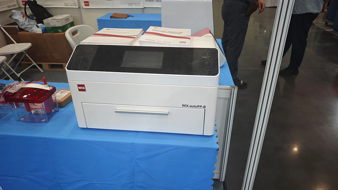 the wix autopp b automated western blot system is displayed prominently at the wix booth, alongside compatible electrophoresis equipment and product brochures.